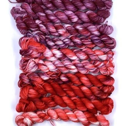 A set of purple and red gradient yarn.