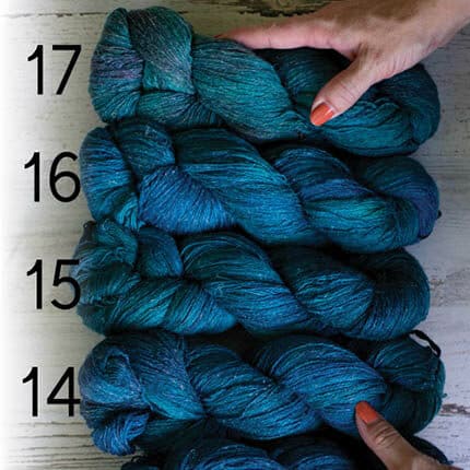 Silk and linen yarn in muted blue colourways labeled from bottom to top with 14, 15, 16 and 17.