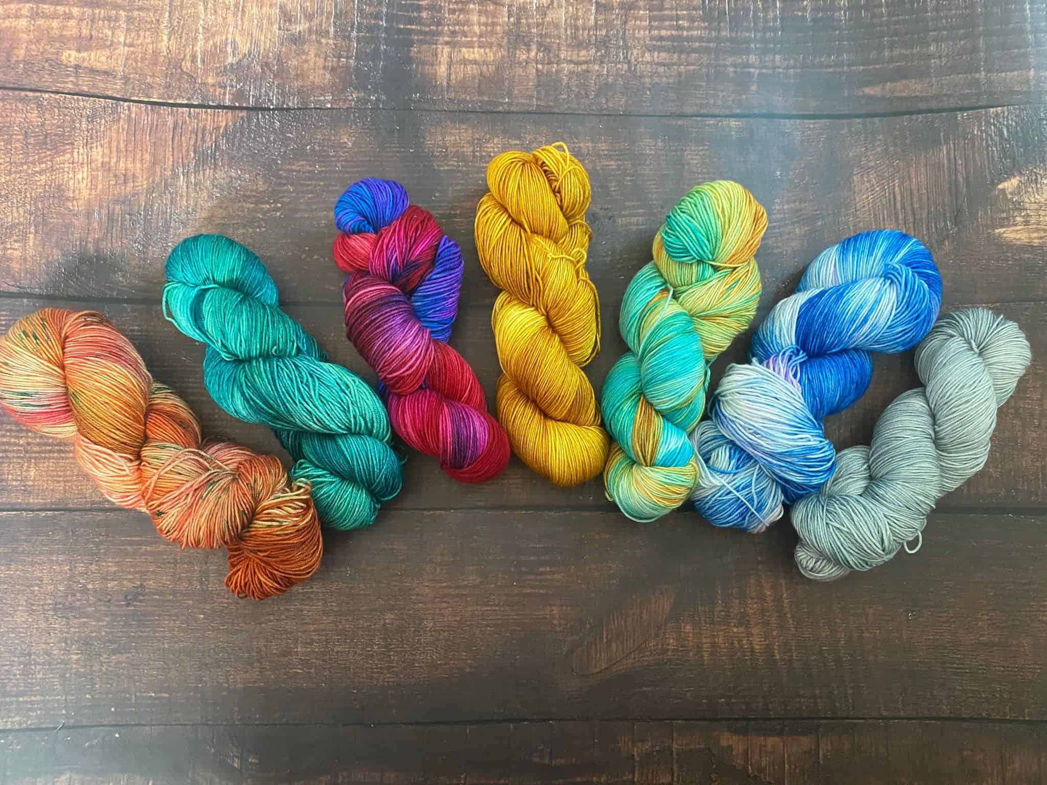 Six skeins of multicolored yarn, all on a superwash merino/silk blend.