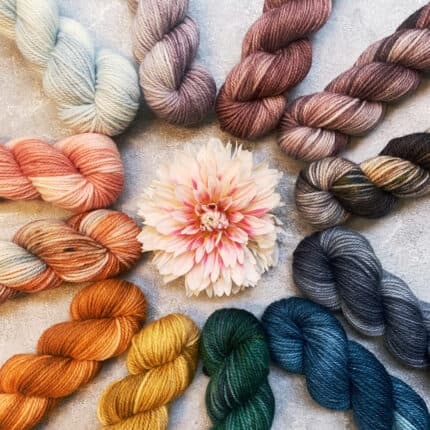 A circle of multicolored mini skeins of yarn.