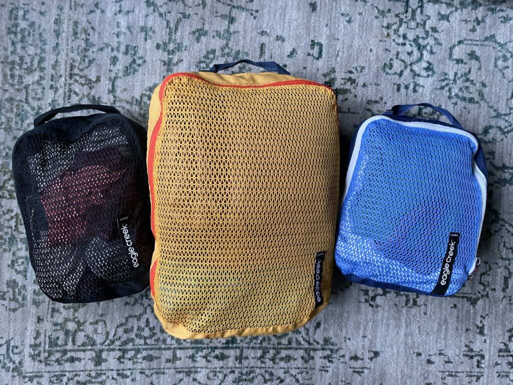 Black, yellow and blue packing cubes.