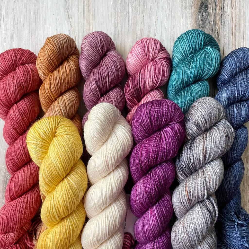 A bundle of yarn skeins in multiple colors.