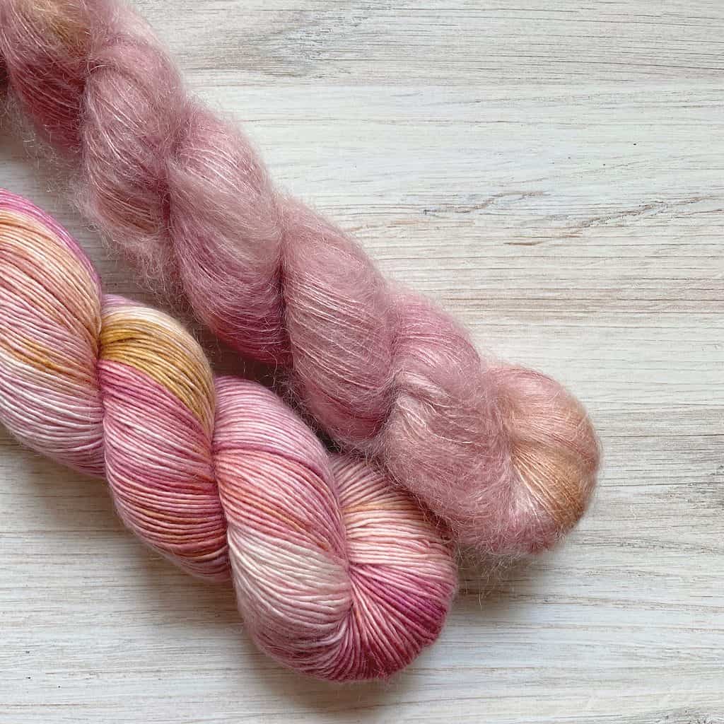Pink single-ply and fuzzy yarn.