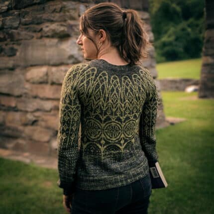 Back view of a light-skinned woman in green colorwork sweater.