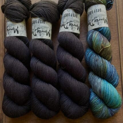 Skeins of dark brown yarn and blue variegated yarn.