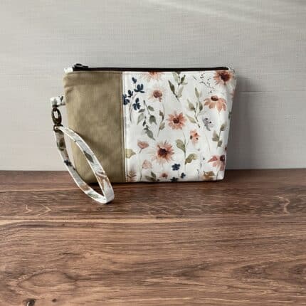 A color block zipper pouch with a sunflower floral print and matching wristlet.