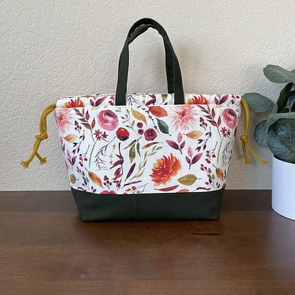 A drawstring bag with floral print in autumn colors.