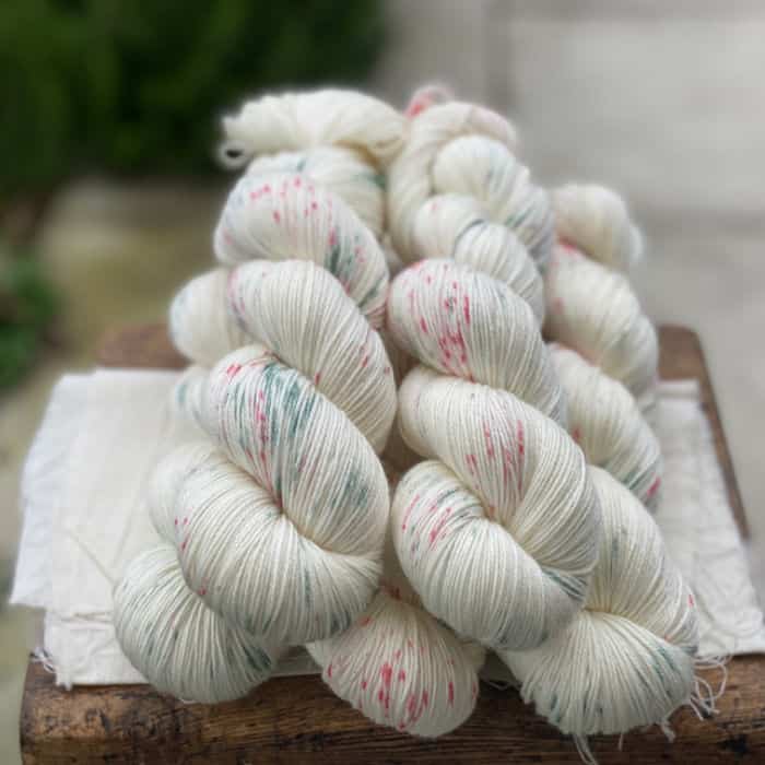 Cream yarn with green and red speckles.