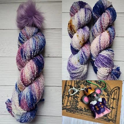 Nutcracker boucle hat kit. Purple, gold, pink, blue bariegated colorway with purple pom pom, mouse king charm to match.