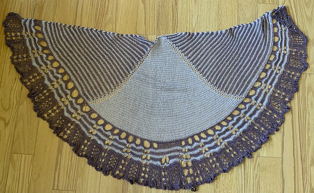 A pruple and white striped and lace shawl.