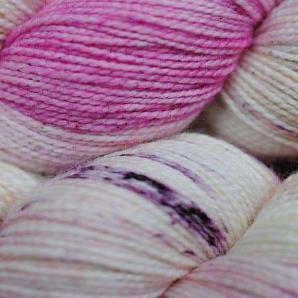 Pink and ivory speckled yarn.