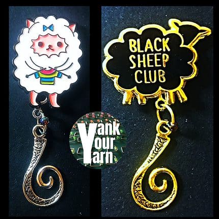 A pair of knitting badges featuring magnetic backs and hanging hooks. One is an image of a black sheep silhouette with the words Black Sheep Club. The other is an image of a cartoon white sheep that is knitting a striped sweater.