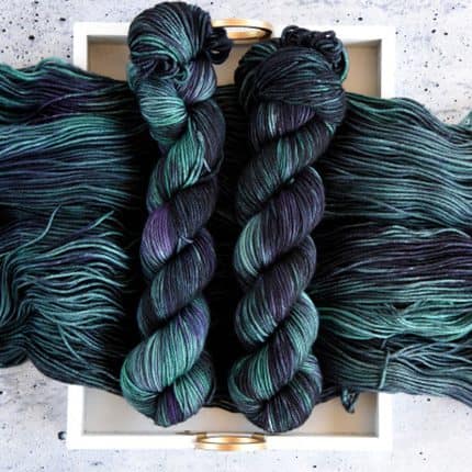 Skeins of green and blue hand-dyed yarn.