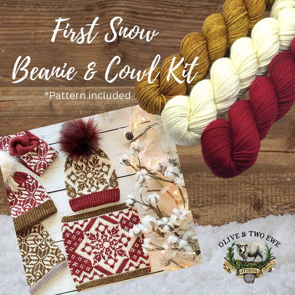 A Beanie and Cowl made with white, red and gold yarn and three hanks of yarn, one in each white, red, and gold with the words "First Snow Beanie & Cowl Kits.”