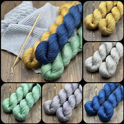 Multiple skeins of cotton yarn in gold, gray, royal blue, and lavender.
