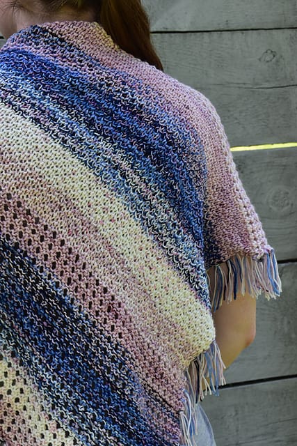 A pink, blue and white textured shawl.