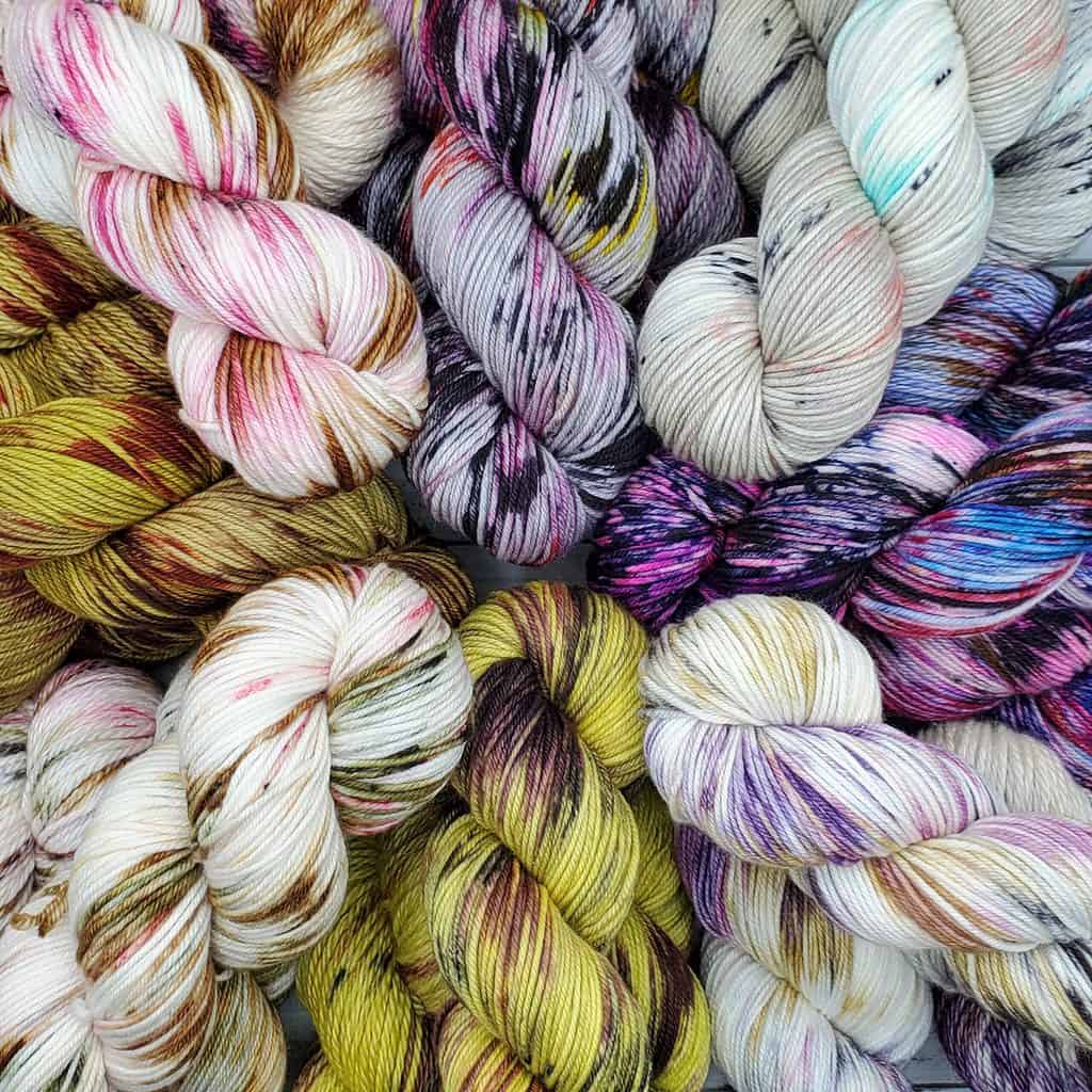 A colorful pile of variegated yarn hanks.