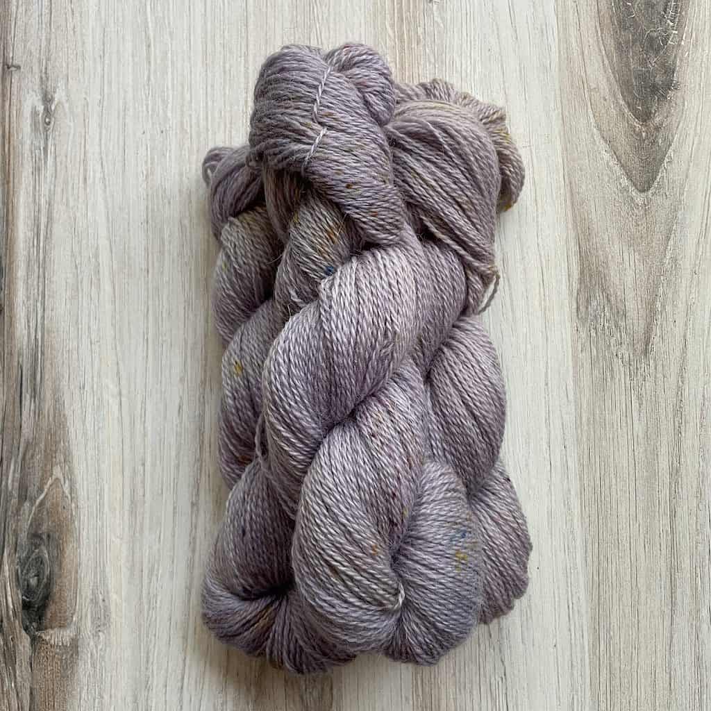 Lightly speckled pale purple yarn.