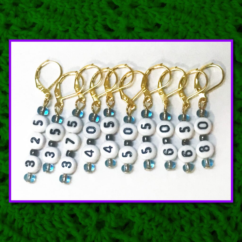 A set of ten stitch markers on leverback earring hooks. Each one has a number to denote the Metric size of a crochet hook. The numbers are: 3.25mm, 3.5mm, 3.75mm, 4mm, 4.5mm, 5mm, 5.5mm, 6mm, 6.5mm, and 8mm.