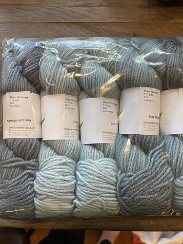Skeins of gray yarn in a clear bag.