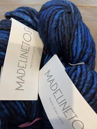 Skeins of dark blue chunky Madelinetosh yarn.