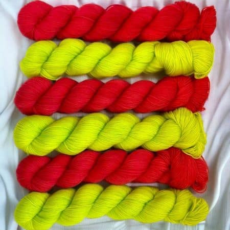 Skeins of bright red and bright green yarn.
