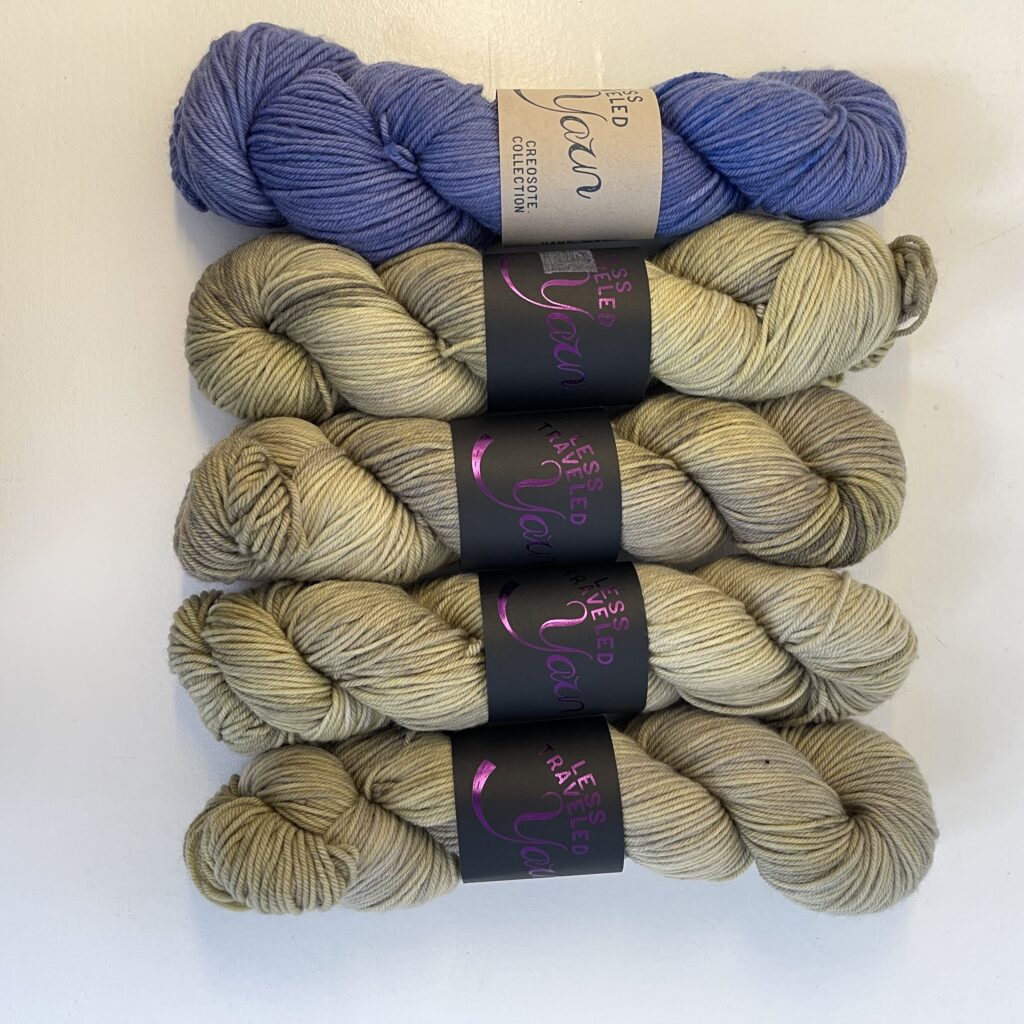 1 skein of purple yarn and 4 skeins of green yarn.