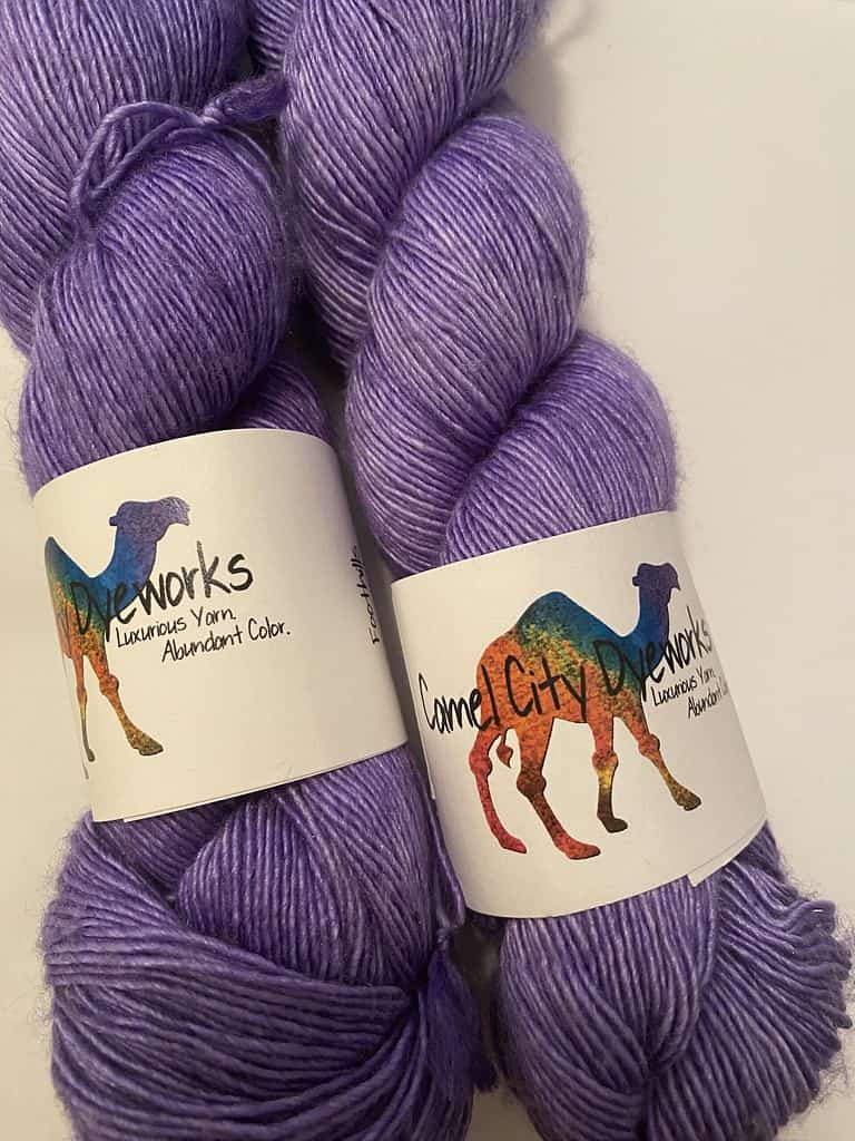 Two skeins of purple yarn.