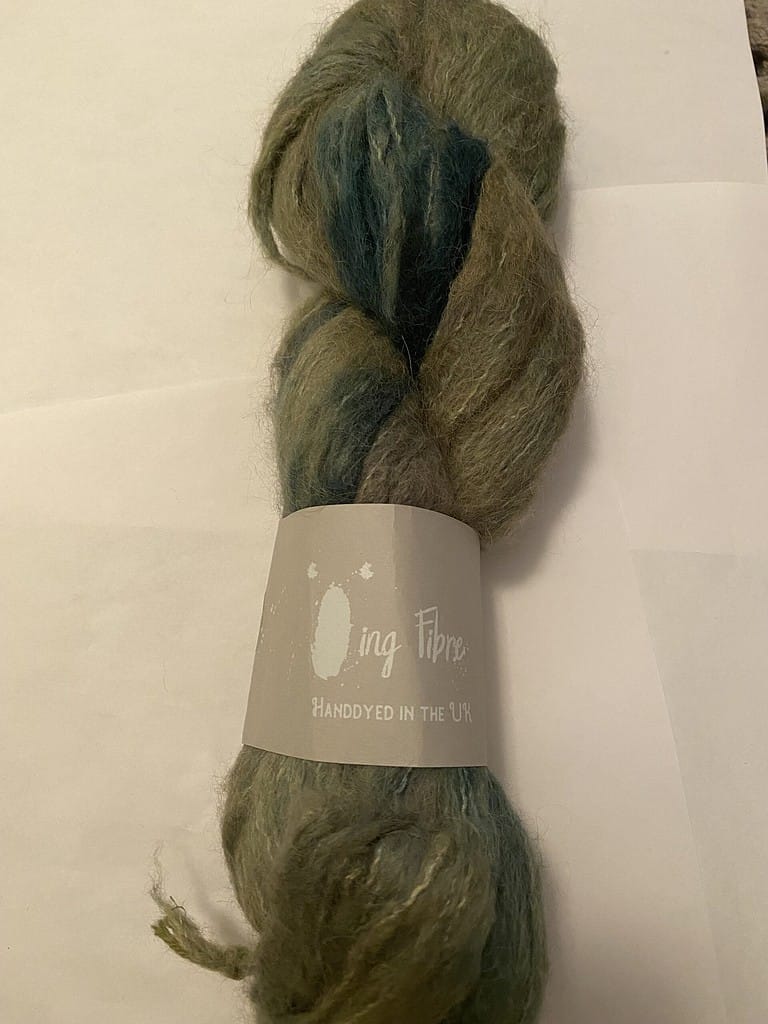 A skein of fuzzy green yarn.