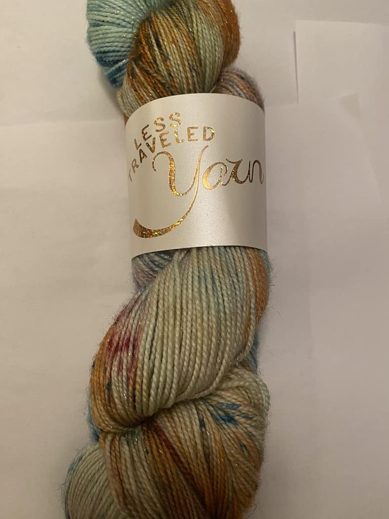 A skein of aqua, gold and pink speckled yarn.