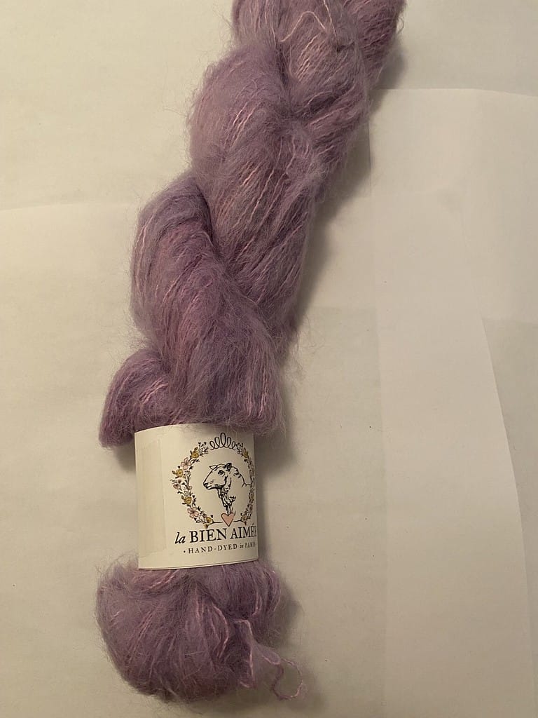 A skein of fuzzy light purple yarn.
