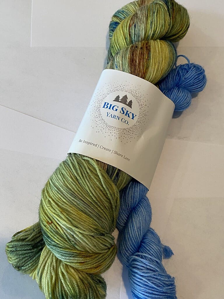 One full skein green and brown yarn, one mini skein blue yarn.