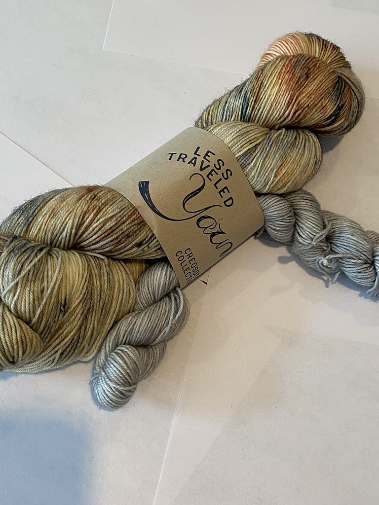 One full skein yarn in green, gray and peach. One mini skein in gray.