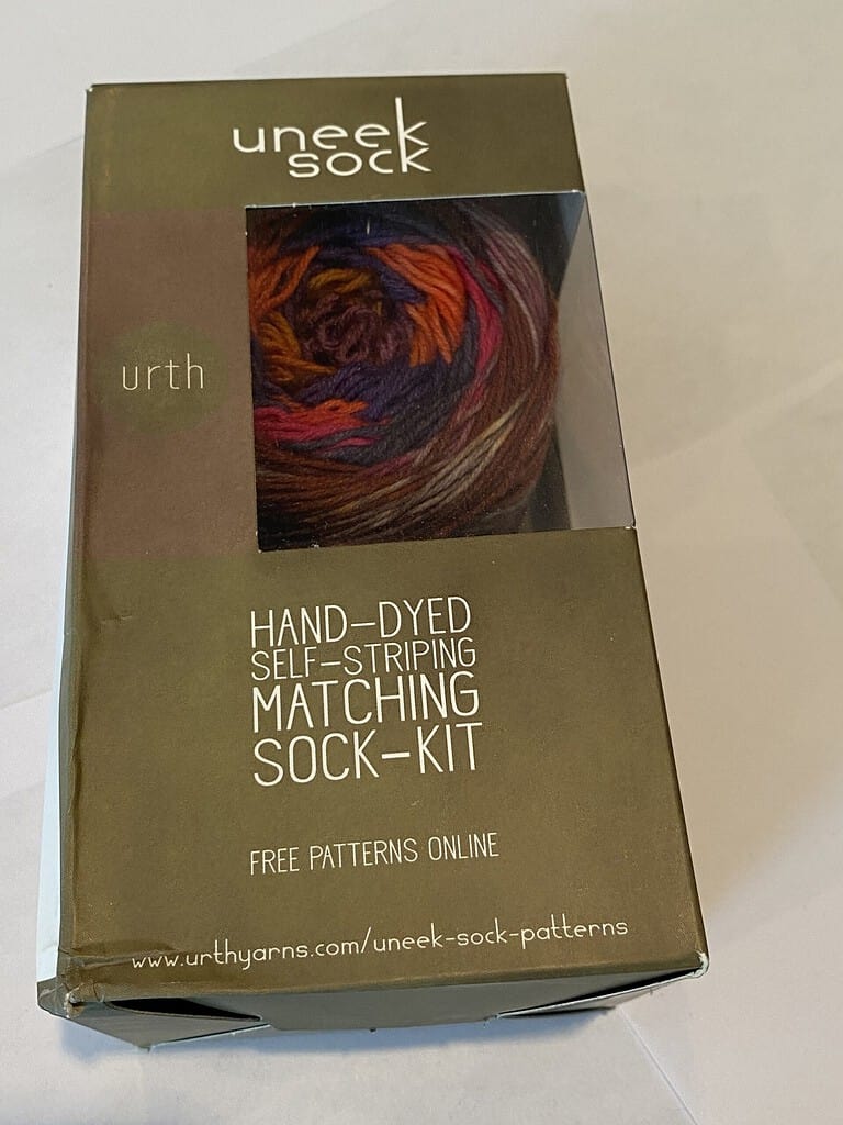 Sock kit with red, orange and brown yarn.