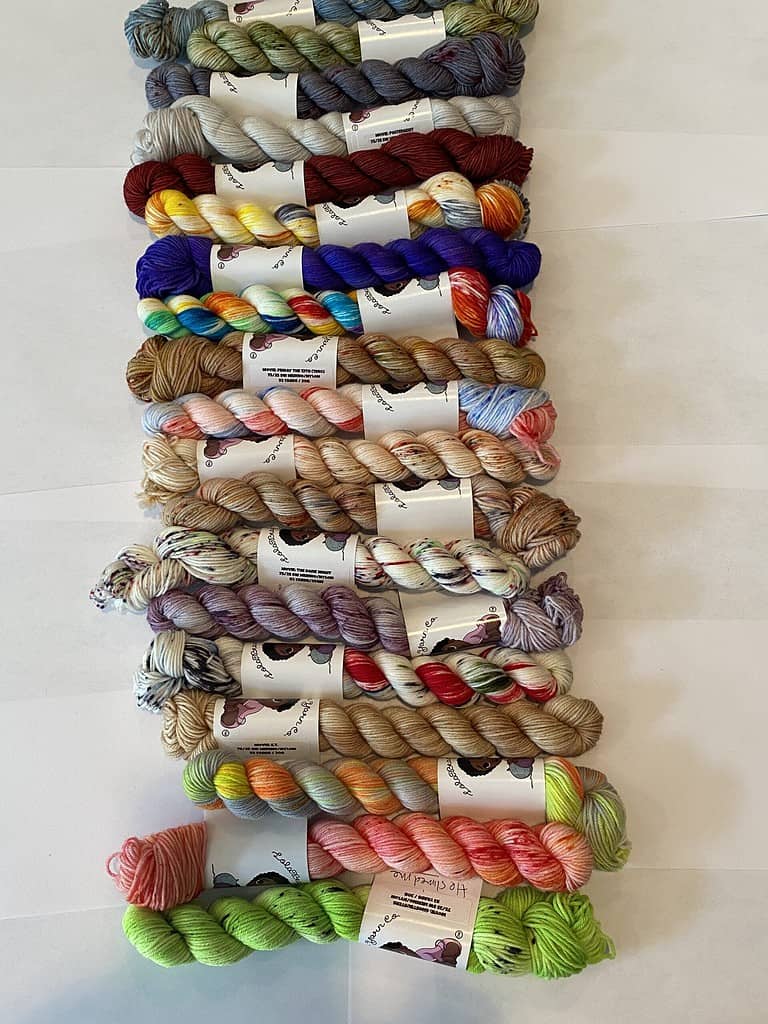 19 mini skeins of bright colored yarn.