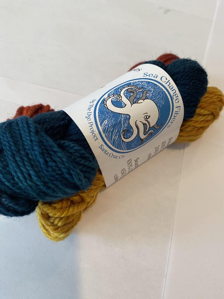 3 skein set of green, red and yellow yarn.