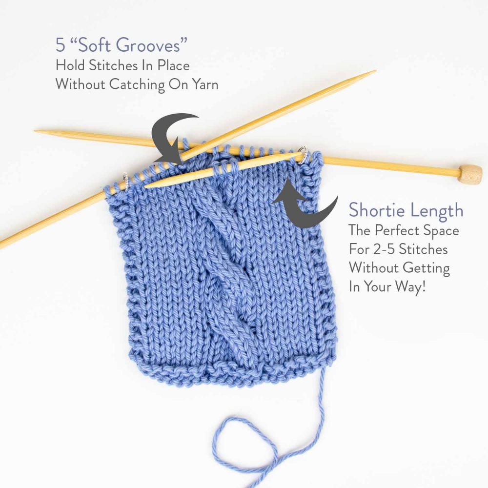 Brown knitting needles on blue yarn with the text 5 "Soft Grooves" Hold stitches in place without catching on yarn and Shortie Length The perfect space for 2-5 stitches without getting in the way!