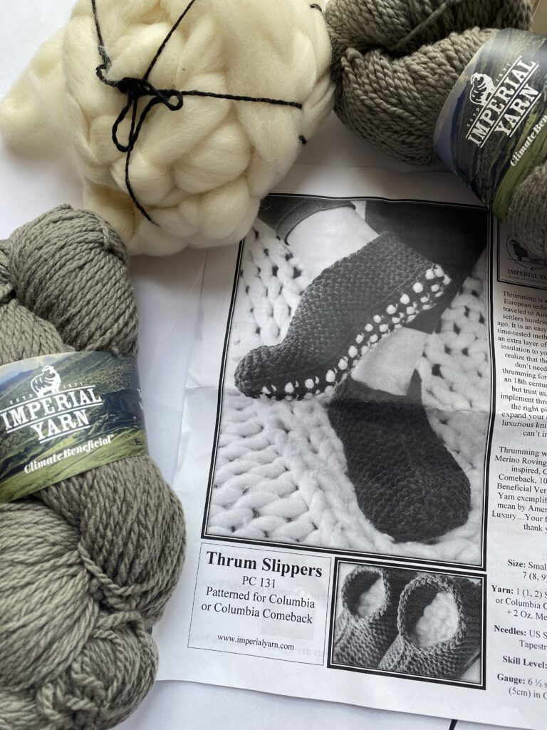 2 skeins gray yarn, roving and slipper pattern.