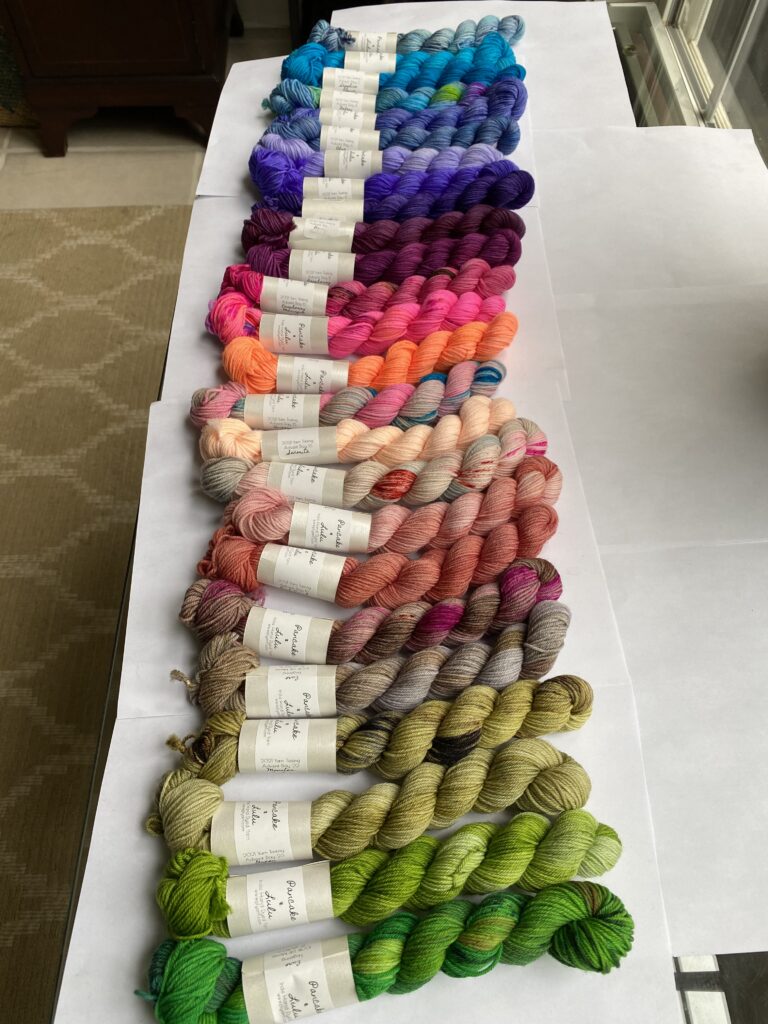 25 mini skeins of yarn in various colors.