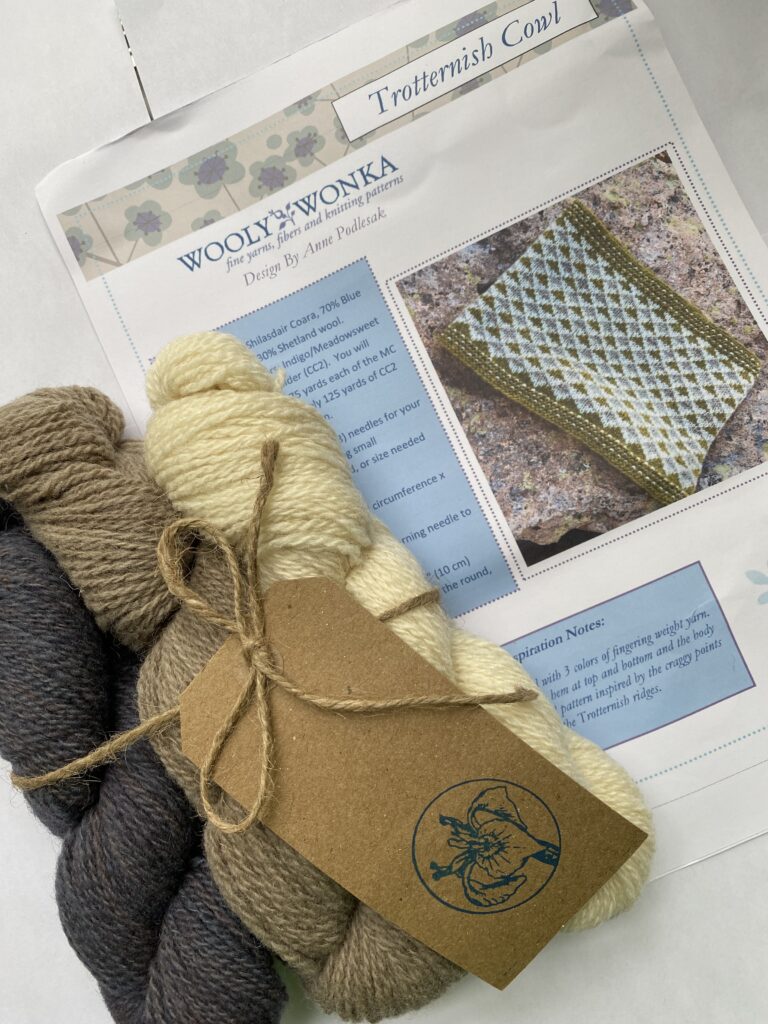 3 skeins natural, brown and gray yarn with cowl pattern.