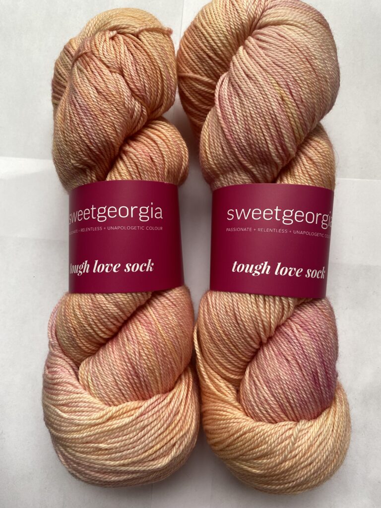 2 skeins of peach yarn.