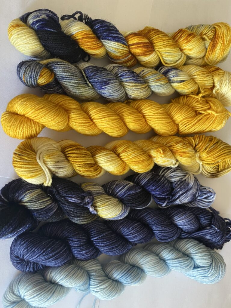 7 skeins of yellow and blue yarn.