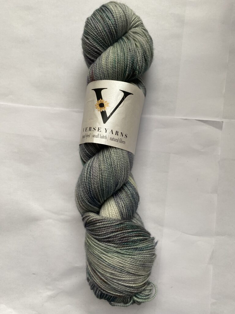 One skein of gray, blue, green yarn.