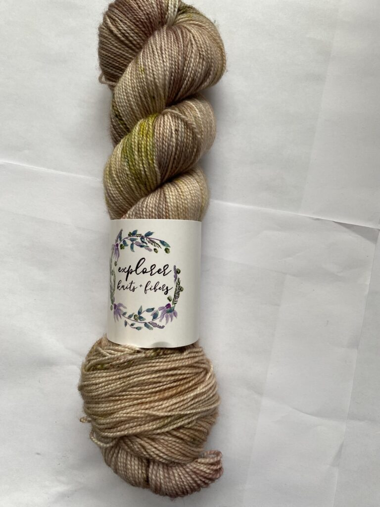 One skein cream, green and brown yarn.