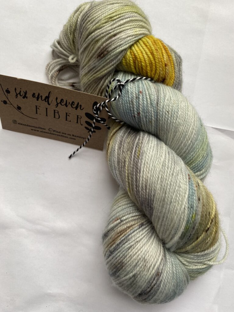 One skein of blue green, brown and yellow yarn.