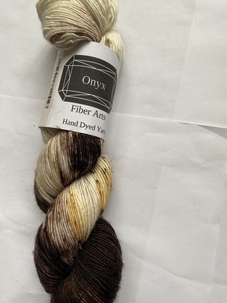 One skein of brown, peach, cream yarn.