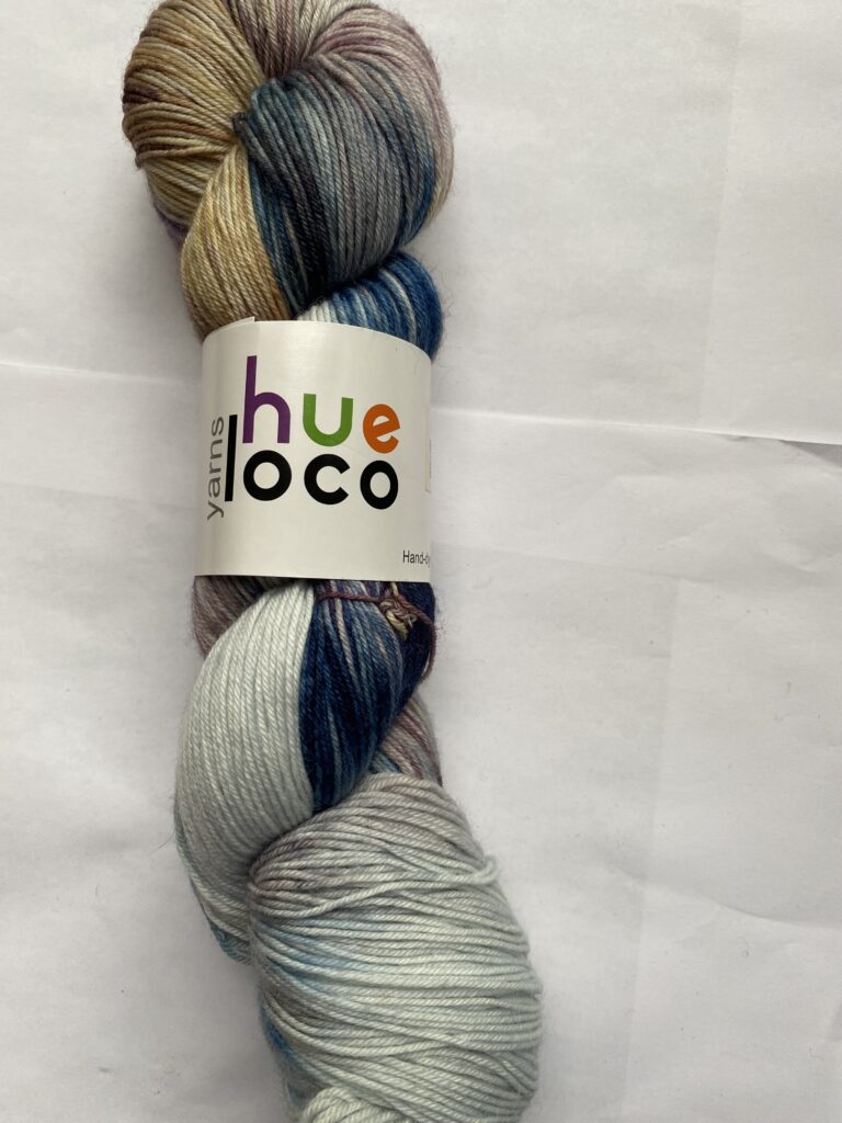 One skein of gray, purple blue and yellow yarn.