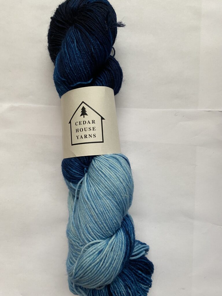 A skein of variegated blue yarn.