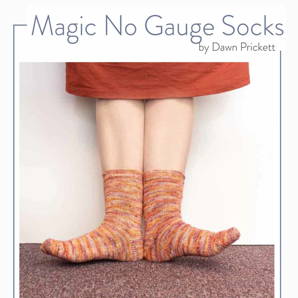 Orange socks on two light-skinned feet with the text Magic No Gauge Socks by Dawn Prickett.