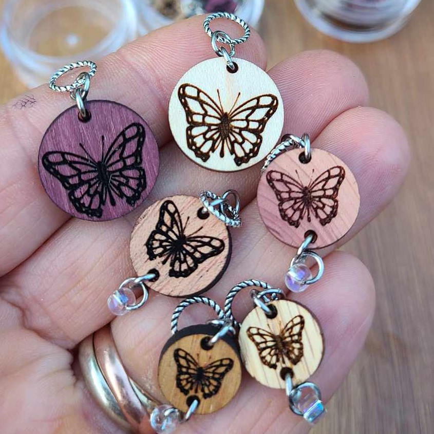 Wooden stitch markers with butterflies.